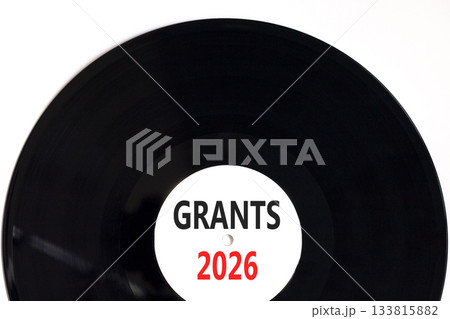 Grants 2026 symbol. Concept words Grants 2026 on beautiful white and black vinyl disk. Beautiful white paper background. Business and grants 2026 concept. Copy space. Grants 2026 symbol. Concept words Grants 2026 on beautiful white and black vinyl disk. Beautiful white paper background. Business and grants 2026 concept. Copy space. 133815882