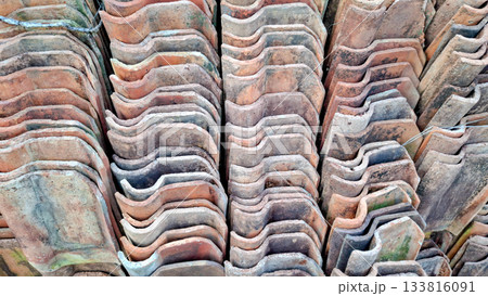 Rhythmic Wavy Pattern of Stacked Terracotta Roof Tiles 133816091