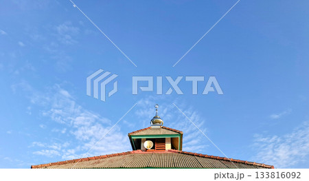 Mosque Roof and Crescent Spire Against Blue Sky and Moon Mosque Roof and Crescent Spire Against Blue Sky and Moon 133816092