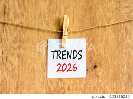 Trends 2026 new year symbol. Concept words Trends 2026 on beautiful white paper on wooden clothespin. Beautiful wooden background. Business and Trends 2026 new year concept. Copy space. 133816219