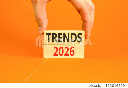 Trends 2026 new year symbol. Concept words Trends 2026 on beautiful wooden blocks. Beautiful orange paper background. Businessman's hand. Business and Trends 2026 new year concept. Copy space. Trends 2026 new year symbol. Concept words Trends 2026 on beautiful wooden blocks. Beautiful orange paper background. Businessman's hand. Business and Trends 2026 new year concept. Copy space. 133816229