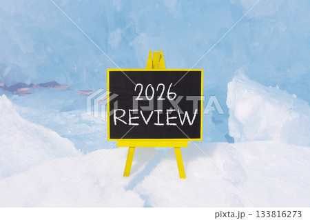 2026 Review symbol. Concept words 2026 Review on beautiful black blackboard. Beautiful blue lake Baikal ice background. Business and 2026 review concept. Copy space. 133816273
