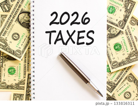 2026 taxes new year symbol. Concept words 2026 taxes on beautiful white note. Beautiful dollar bills background. Black pen. Dollar bills. Business and 2026 taxes new year concept. Copy space. 2026 taxes new year symbol. Concept words 2026 taxes on beautiful white note. Beautiful dollar bills background. Black pen. Dollar bills. Business and 2026 taxes new year concept. Copy space. 133816311