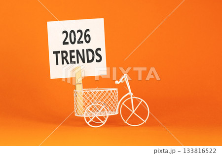 2026 Trends symbol. Concept words 2026 Trends on beautiful white paper on wooden clothespin. Beautiful orange background. Beautiful miniature bicycle. Business 2026 Trends new year concept. Copy space 133816522