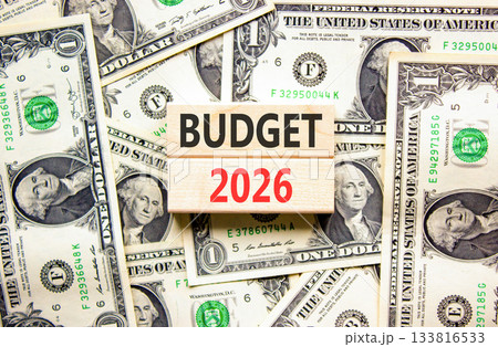Budget 2026 symbol. Concept words Budget 2026 on beautiful wooden blocks. Beautiful dollar bills background. Dollar bills. Business and budget 2026 concept. Copy space. Budget 2026 symbol. Concept words Budget 2026 on beautiful wooden blocks. Beautiful dollar bills background. Dollar bills. Business and budget 2026 concept. Copy space. 133816533