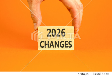 2026 Changes symbol. Concept words 2026 Changes on beautiful wooden blocks. Beautiful orange paper background. Businessman's hand. Business and 2026 changes concept. Copy space. 133816536