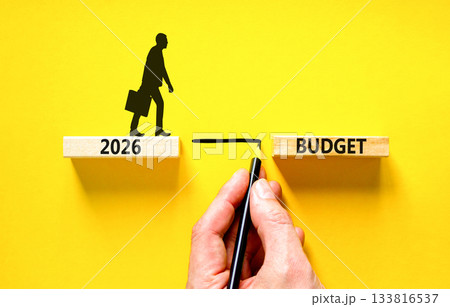 2026 Budget symbol. Concept words 2026 Budget on beautiful wooden blocks. Beautiful yellow background. Businessman holds pencil. Businessman icon. Business and 2026 budget concept. Copy space. 2026 Budget symbol. Concept words 2026 Budget on beautiful wooden blocks. Beautiful yellow background. Businessman holds pencil. Businessman icon. Business and 2026 budget concept. Copy space. 133816537
