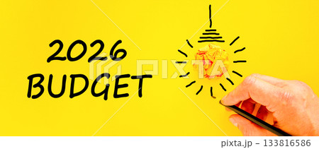 2026 Budget symbol. Concept words 2026 Budget on beautiful yellow paper. Beautiful orange paper background. Light bulb icon. Businessman's hand with pen. Business and 2026 budget concept. Copy space. 2026 Budget symbol. Concept words 2026 Budget on beautiful yellow paper. Beautiful orange paper background. Light bulb icon. Businessman's hand with pen. Business and 2026 budget concept. Copy space. 133816586