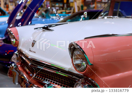 Classic 1950s historical car displayed in vintage auto show surrounded by vehicles Classic 1950s historical car displayed in vintage auto show surrounded by vehicles 133816779