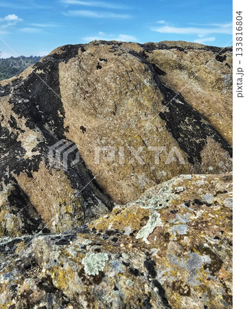 Rugged, Textured Mountain Slope under a Bright Sky 133816804