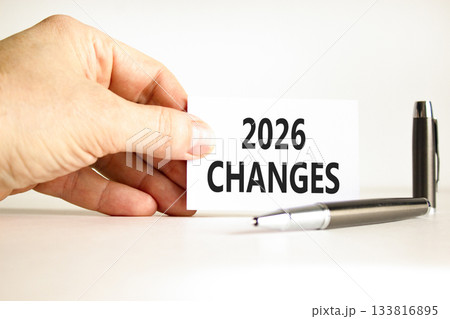 2026 Changes symbol. Concept words 2026 Changes on beautiful white card. Beautiful white paper background. Businessman's hand. Business and 2026 changes concept. Copy space. 133816895