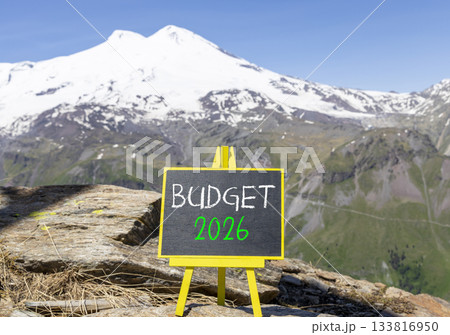 Budget 2026 symbol. Concept words Budget 2026 on beautiful black blackboard. Beautiful mountain Elbrus and blue sky background. Business and budget 2026 concept. Copy space. Budget 2026 symbol. Concept words Budget 2026 on beautiful black blackboard. Beautiful mountain Elbrus and blue sky background. Business and budget 2026 concept. Copy space. 133816950