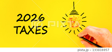 2026 taxes new year symbol. Concept words 2026 taxes on beautiful yellow paper. Beautiful orange paper background. Businessman's hand with pen. Business and 2026 taxes new year concept. Copy space. 2026 taxes new year symbol. Concept words 2026 taxes on beautiful yellow paper. Beautiful orange paper background. Businessman's hand with pen. Business and 2026 taxes new year concept. Copy space. 133816957