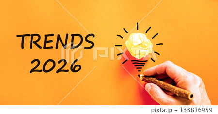 Trends 2026 new year symbol. Concept words Trends 2026 on beautiful orange paper. Beautiful orange paper background. Businessman's hand with pen. Business and Trends 2026 new year concept. Copy space. Trends 2026 new year symbol. Concept words Trends 2026 on beautiful orange paper. Beautiful orange paper background. Businessman's hand with pen. Business and Trends 2026 new year concept. Copy space. 133816959