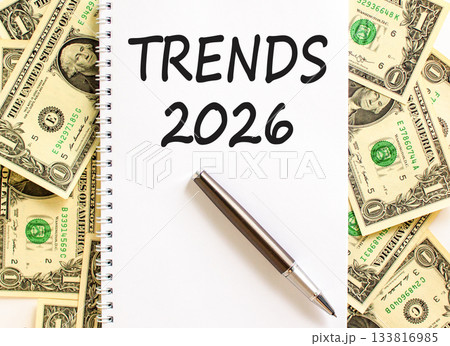 Trends 2026 new year symbol. Concept words Trends 2026 on beautiful white note. Beautiful dollar bills background. Black pen. Dollar bills. Business and Trends 2026 new year concept. Copy space. Trends 2026 new year symbol. Concept words Trends 2026 on beautiful white note. Beautiful dollar bills background. Black pen. Dollar bills. Business and Trends 2026 new year concept. Copy space. 133816985