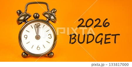 2026 Budget symbol. Concept words 2026 Budget on beautiful orange paper. Beautiful orange paper background. Beautiful black alarm clock. Business and 2026 budget concept. Copy space. 2026 Budget symbol. Concept words 2026 Budget on beautiful orange paper. Beautiful orange paper background. Beautiful black alarm clock. Business and 2026 budget concept. Copy space. 133817000