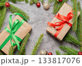 Christmas composition. Gift boxes, fir tree branches, red and gold decorations on grey background. High quality photo 133817076
