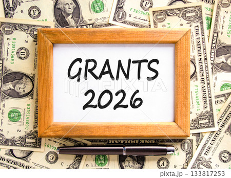 Grants 2026 symbol. Concept words Grants 2026 on beautiful wooden picture frame. Beautiful dollar bills background. Black pen. Dollar bills. Business and grants 2026 concept. Copy space. Grants 2026 symbol. Concept words Grants 2026 on beautiful wooden picture frame. Beautiful dollar bills background. Black pen. Dollar bills. Business and grants 2026 concept. Copy space. 133817253