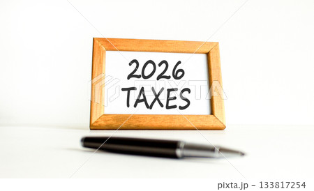 2026 taxes new year symbol. Concept words 2026 taxes on beautiful wooden picture frame. Beautiful white paper background. Beautiful black pen. Business and 2026 taxes new year concept. Copy space. 2026 taxes new year symbol. Concept words 2026 taxes on beautiful wooden picture frame. Beautiful white paper background. Beautiful black pen. Business and 2026 taxes new year concept. Copy space. 133817254