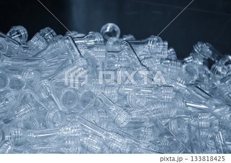 Close up scene of group of preform shape of PET bottle products in the light blue scene. Close up scene of group of preform shape of PET bottle products in the light blue scene. 133818425