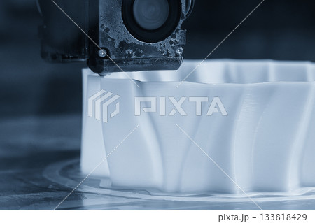Close up scene the 3D model operation by additive manufacturing by 3D printer machine in the blue scene tone. 133818429
