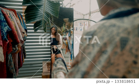 Suspenseful Encounter in a Vintage Clothing Shop filled with diverse and vibrant styles and designs Suspenseful Encounter in a Vintage Clothing Shop filled with diverse and vibrant styles and designs 133818651