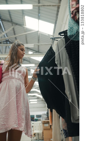 A Fashionista Enjoying Shopping for Trendy Clothes in an Elegant and Modern Boutique Store A Fashionista Enjoying Shopping for Trendy Clothes in an Elegant and Modern Boutique Store 133818802
