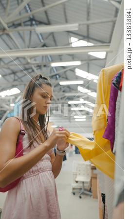 A Fashion Enthusiast Enjoys Exploring a Colorful and Diverse Clothing Rack Full of Styles 133818841