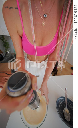 A stylish cooking scene featuring a colorful outfit complemented by various preparations 133819126
