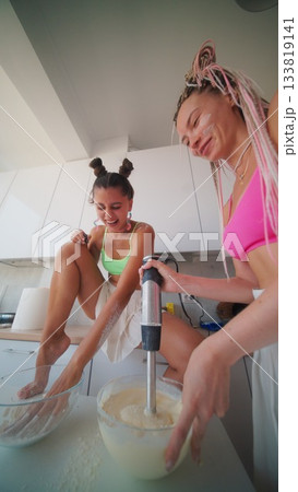 Enjoying a Fun Baking Moment with Friends While Wearing Vibrant and Colorful Swimwear Enjoying a Fun Baking Moment with Friends While Wearing Vibrant and Colorful Swimwear 133819141