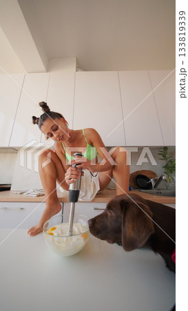 A vibrant and cozy kitchen scene featuring a cheerful dog engaged in cooking activities 133819339