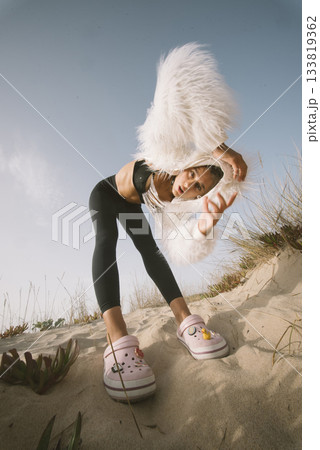 A Dynamic Fashion Pose on the Beach Showcasing a Stylish and Trendy Outfit Collection 133819362