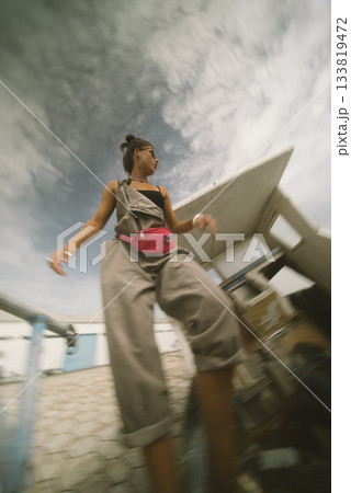 Candid Style Fashion Snapshot Captured in an Urban Setting with a Beautiful Cloudy Sky Candid Style Fashion Snapshot Captured in an Urban Setting with a Beautiful Cloudy Sky 133819472