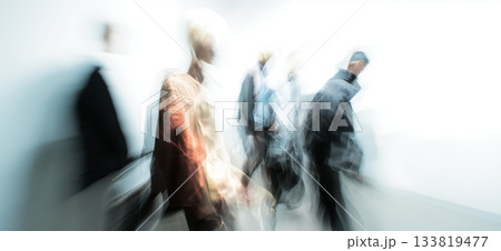 Diverse individuals move creating streaks of colorful motion against a light background. Blurred people banner 133819477