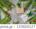 Christmas composition. Gift boxes, fir tree branches, red and gold decorations on grey background. High quality photo 133820127