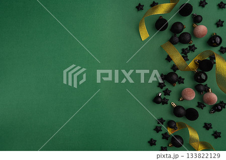 Black Ornaments and Stars Frame with Gold Ribbon on Green Black Ornaments and Stars Frame with Gold Ribbon on Green 133822129