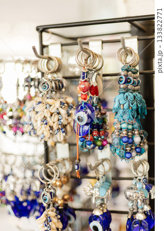 This bustling craft market features a rack filled with unique handmade earrings. Each piece showcases intricate designs, bright colors, and cultural elements typical of Turkish crafts 133822771