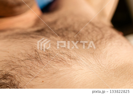 This scene focuses on the close-up of body hair, showcasing the natural texture. It reflects personal grooming practices and the emphasis on smooth skin This scene focuses on the close-up of body hair, showcasing the natural texture. It reflects personal grooming practices and the emphasis on smooth skin 133822825