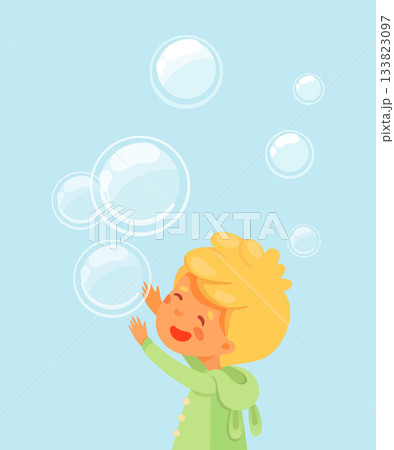 Boy playing with soap bubbles. Happy blonde kid in green coat reaching up on blue background with floating translucent spheres. Joyful childhood moment in soft cartoon vector illustration 133823097