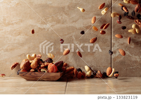 Mix of dried fruits and nuts in motion. Mix of dried fruits and nuts in motion. 133823119