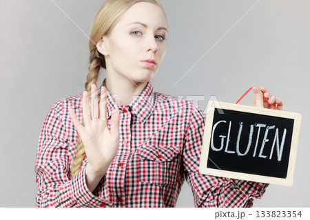 Woman holding board with gluten sign Woman holding board with gluten sign 133823354