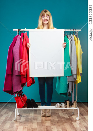 Woman in mall wardrobe with blank banner copyspace Woman in mall wardrobe with blank banner copyspace 133823385