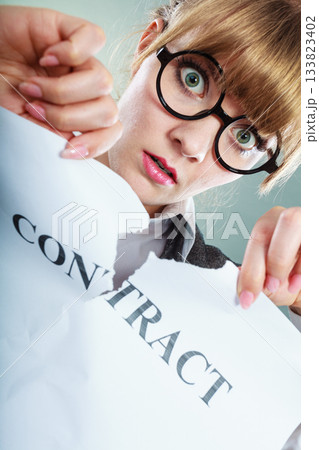 unhappy business woman showing crumpled contract 133823402