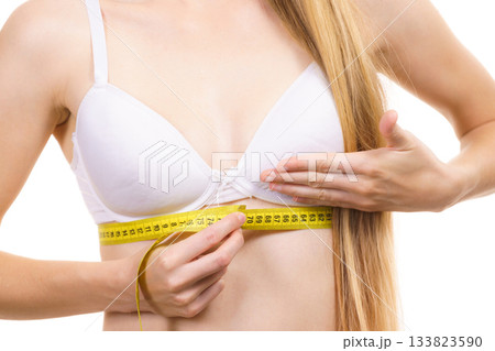 Woman measuring her chest under breast 133823590