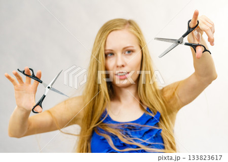 Girl with scissors for haircutting Girl with scissors for haircutting 133823617