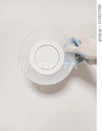 Vertical view of installing new round wall sconces. Vertical view of installing new round wall sconces. 133823766