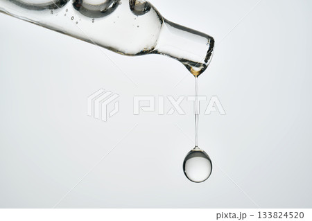 Cosmetic pipette dispensing serum drop for skincare routine 133824520