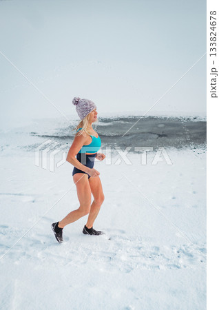 Elderly winter swimmer warming up before cold plunge in lake. 133824678