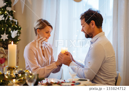 Christmas romance for couple, holding cande. 133824712
