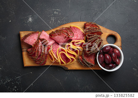 Charcuterie platter meat sliced salami pepperoni olives snack appetizer wooden board antipasto Charcuterie platter meat sliced salami pepperoni olives snack appetizer wooden board antipasto 133825582